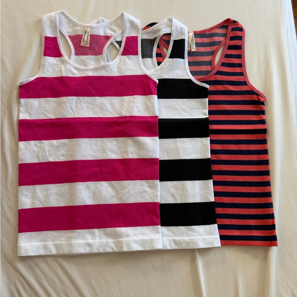 Brand new Lot of 3 stretchy racer back tanks one size fits most.